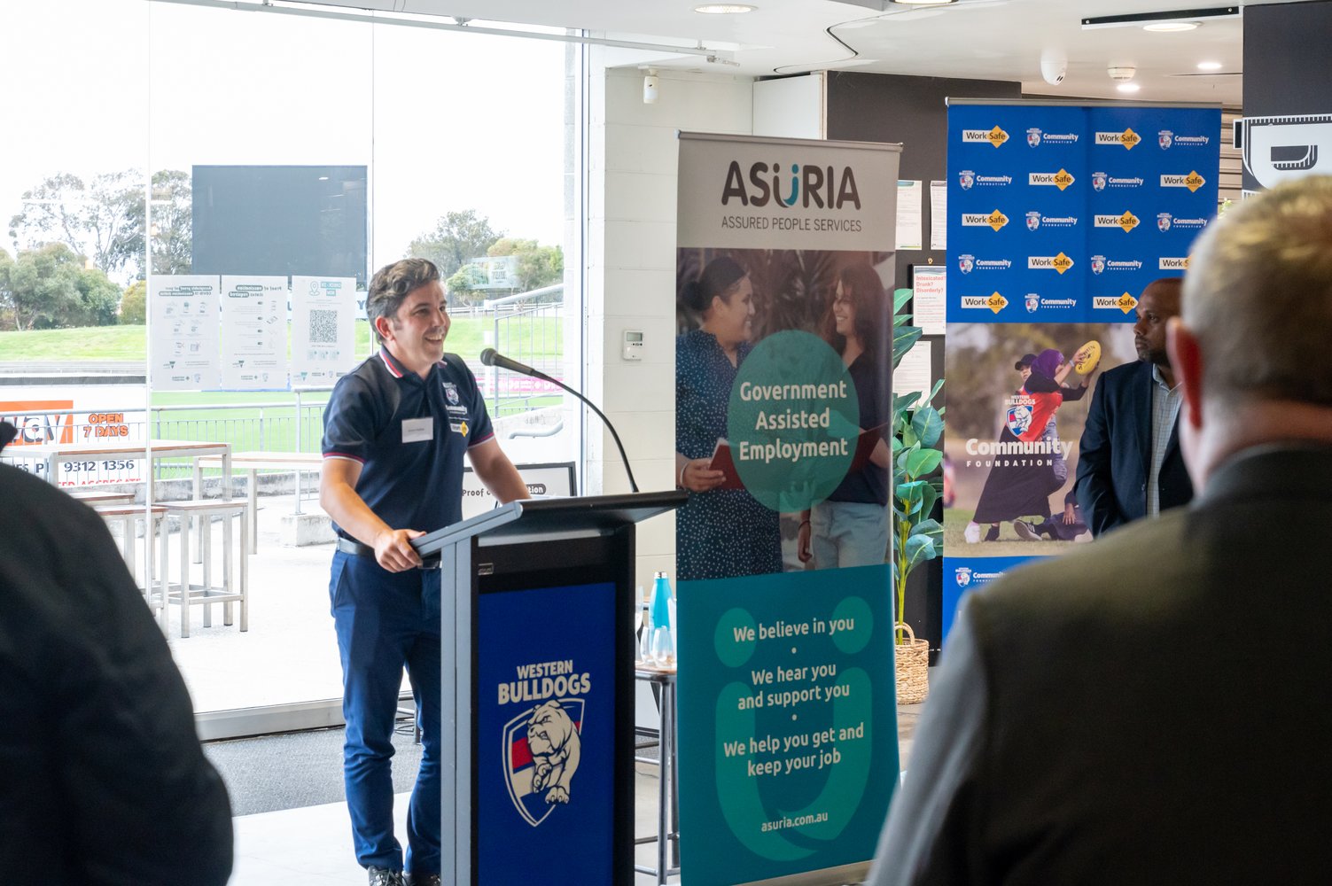 Western Bulldogs Community Foundation, Diversity and Youth Manager, Simon Rodder speaking at the Asuria JVES launch in front of guests as VU Whitten Oval