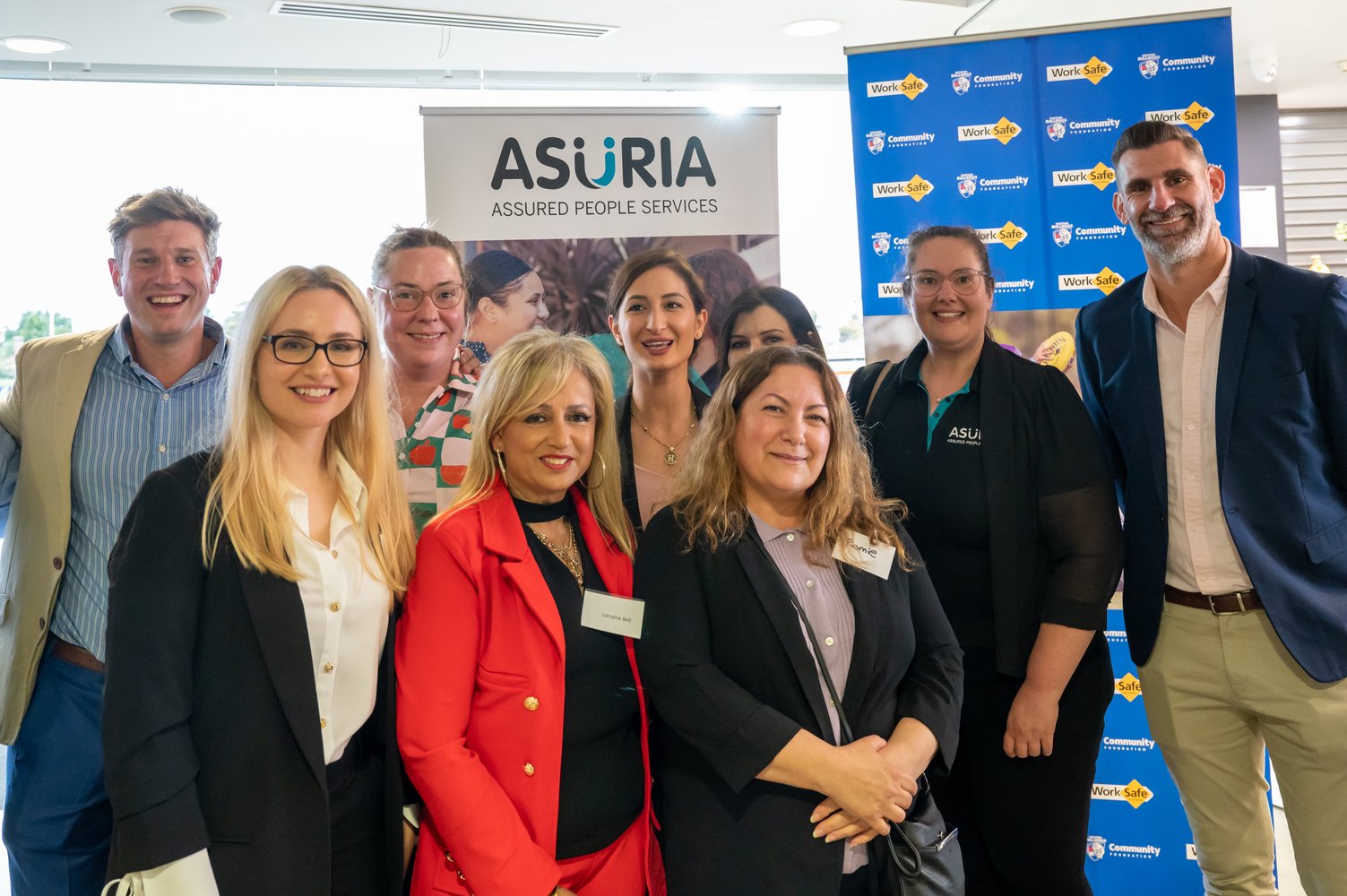 Asuria jobs Victoria employment services team smiling all together at the Asuria and Western Bulldogs JVES launch at VU Whitten Oval